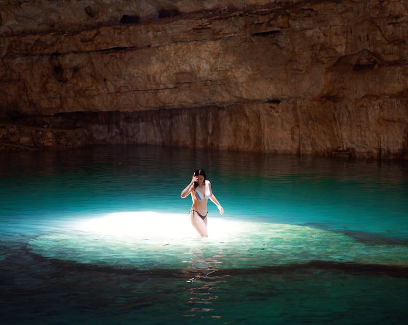a woman bathing in a cavern